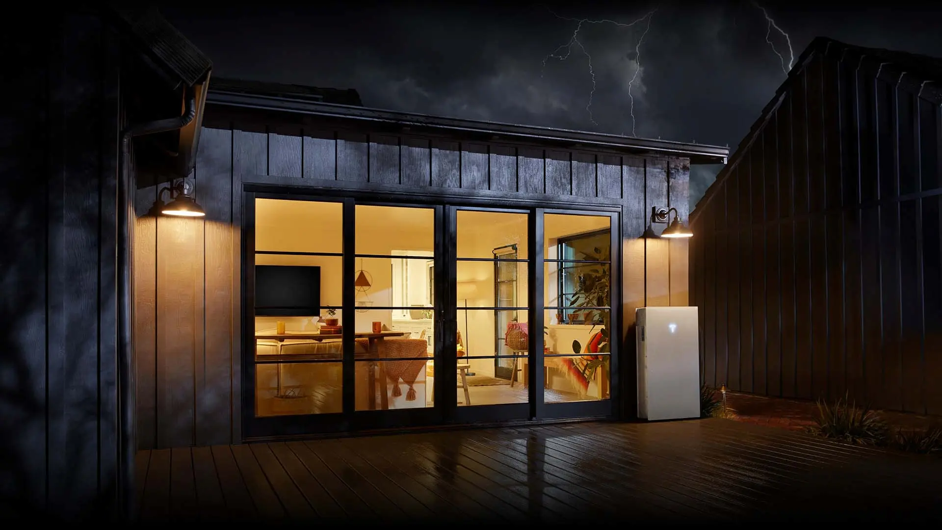 Home with Tesla Powerwall illuminated during a storm